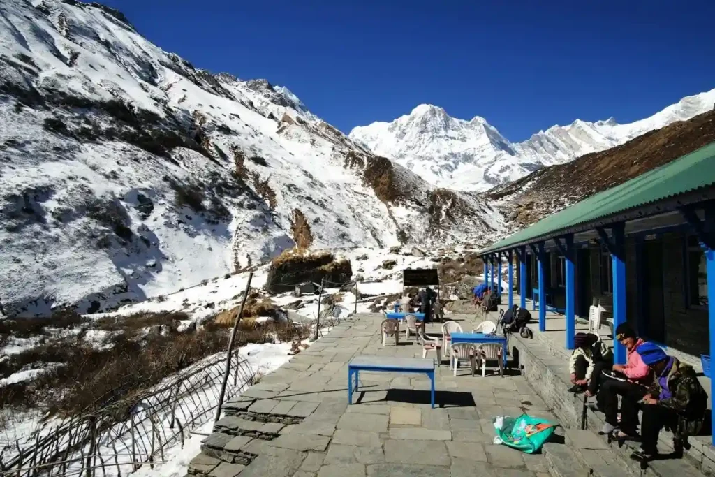Trekkers outside a teahouse on the Annapurna Base Camp trek in Nepal