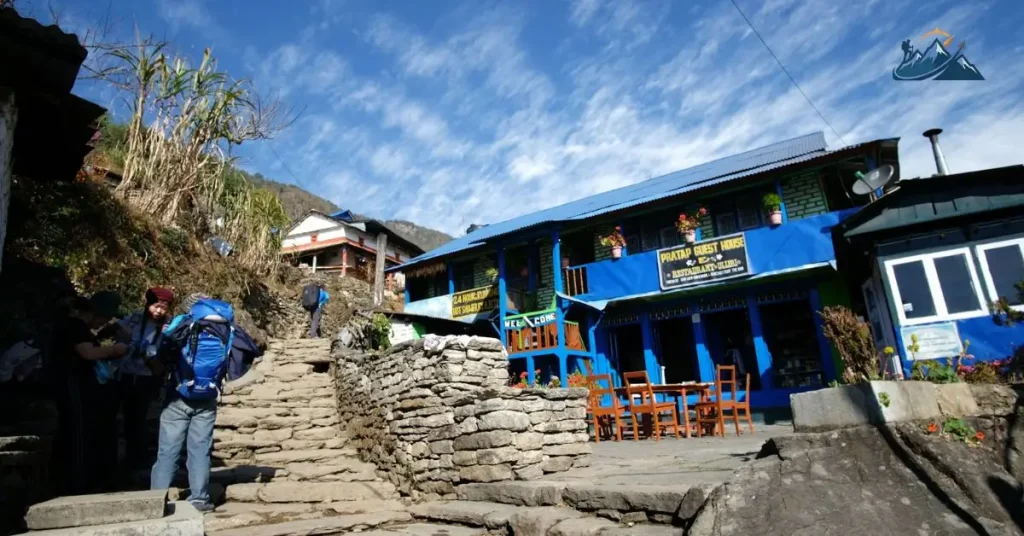 Trekker climbing steep stone steps on the Annapurna Base Camp trail in Nepal